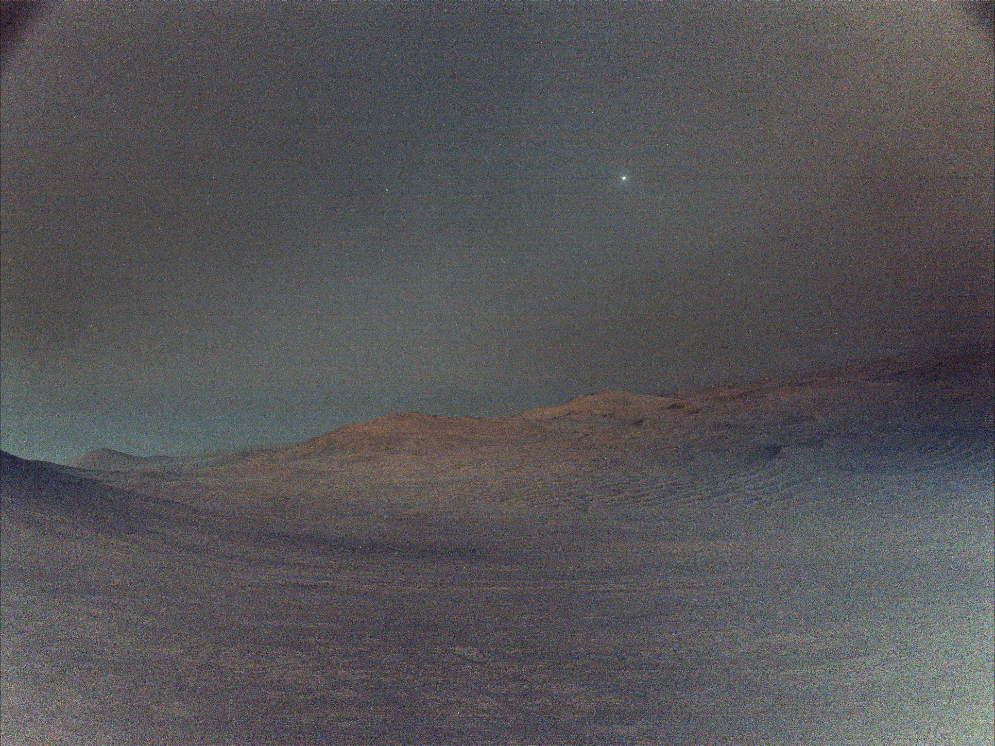 Deimos takes 30 hours and 18 minutes to complete one orbit around the Red Planet. That's a little more than one Martian day or sol which is about 24 hours and 40 minutes long, so Deimos drifts westward across the Martian sky. About 15 kilometers across at its widest, the smallest of Mars' two moons is bright though. In fact Deimos is the brightest celestial object in this Martian skyscape captured before sunrise by Perseverance on March 1, the 1,433rd sol of the Mars rover's mission. The image is a composed of 16 exposures recorded by one of the rover's navigation cameras. The individual exposures were combined into a single image for an enhanced low light view. Regulus and Algieba, bright stars in the constellation Leo, are also visible in the dark Martian predawn sky.