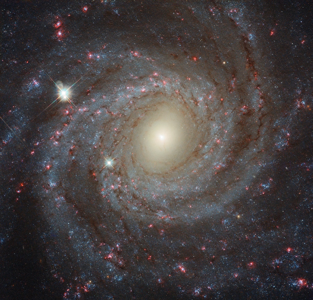 From our vantage point in the Milky Way Galaxy, we see NGC 3344 face-on. Nearly 40,000 light-years across, the big, beautiful spiral galaxy is located just 20 million light-years away in the constellation of Leo Minor. This multi-color Hubble Space Telescope close-up of NGC 3344 includes remarkable details from near infrared to ultraviolet wavelengths. The frame extends some 15,000 light-years across the spiral's central regions. From the core outward, the galaxy's colors change from the yellowish light of old stars in the center to young blue star clusters and reddish star forming regions along the loose, fragmented spiral arms. Of course, the bright stars with a spiky appearance are in front of NGC 3344 and lie well within our own Milky Way. APOD Turns 30!: Free Public Lecture in Anchorage on Wednesday, June 11 at 7 pm