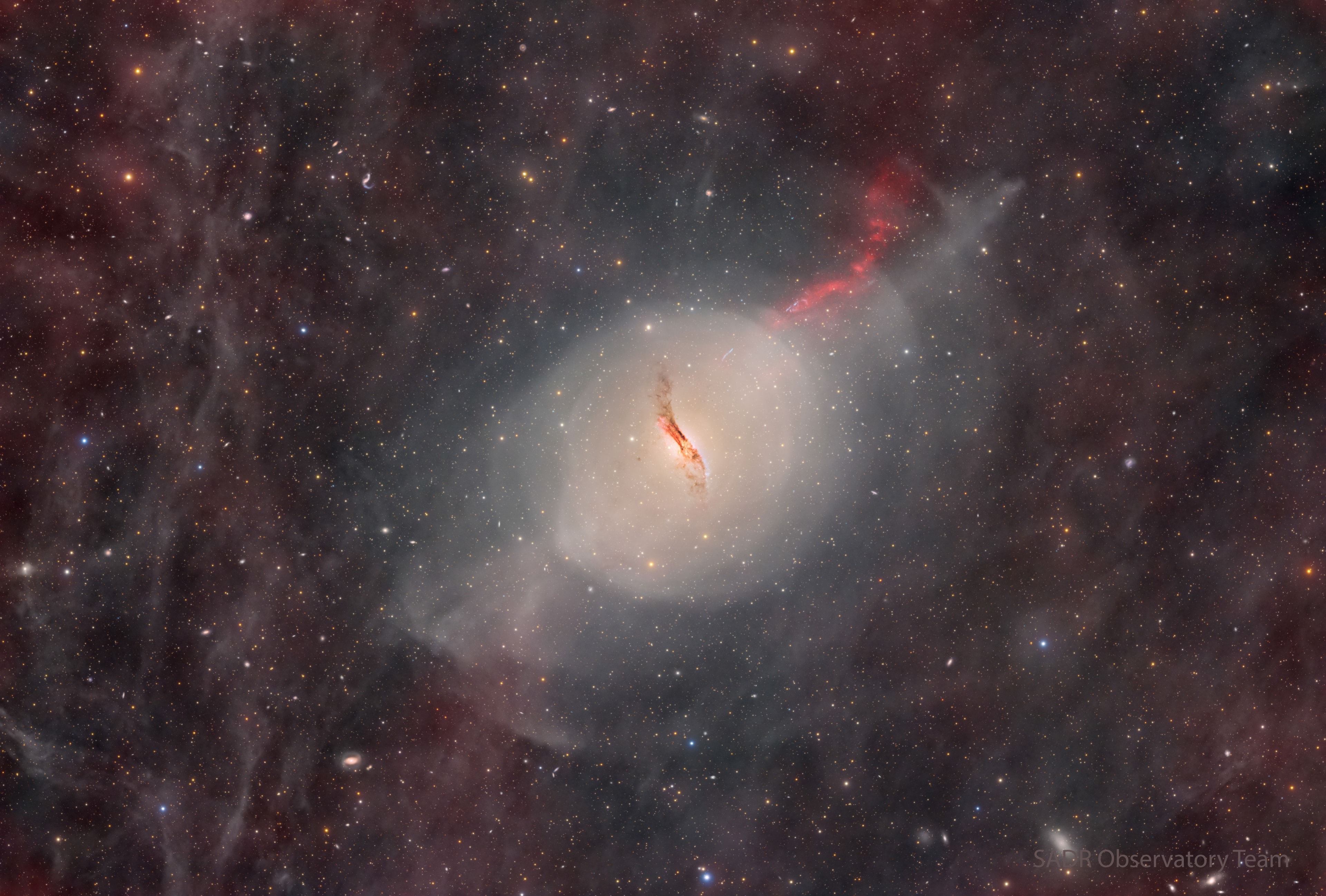 What's happened to the center of this galaxy? Dramatic dust lanes run across the center of unusual elliptical galaxy Centaurus A. These dust lanes are so thick they almost completely obscure the galaxy's center in visible light. This is particularly unusual as Cen A's older stars and oval shape are characteristic of a giant elliptical galaxy, a galaxy type typically low in dark dust. Pictured in this deep image is a complex network of foreground gas and dust, as well as shells of dim stars and a jet projecting to the upper right. Also known as NGC 5128, Cen A is surely the result of a galactic collision where many young dust-creating stars were formed. However, details of the creation of Cen A's unusually active center and iconic central dust lanes are still being researched. Cen A lies only 13 million light years away, making it the closest active galaxy. Jigsaw Galaxy: Astronomy Puzzle of the Day